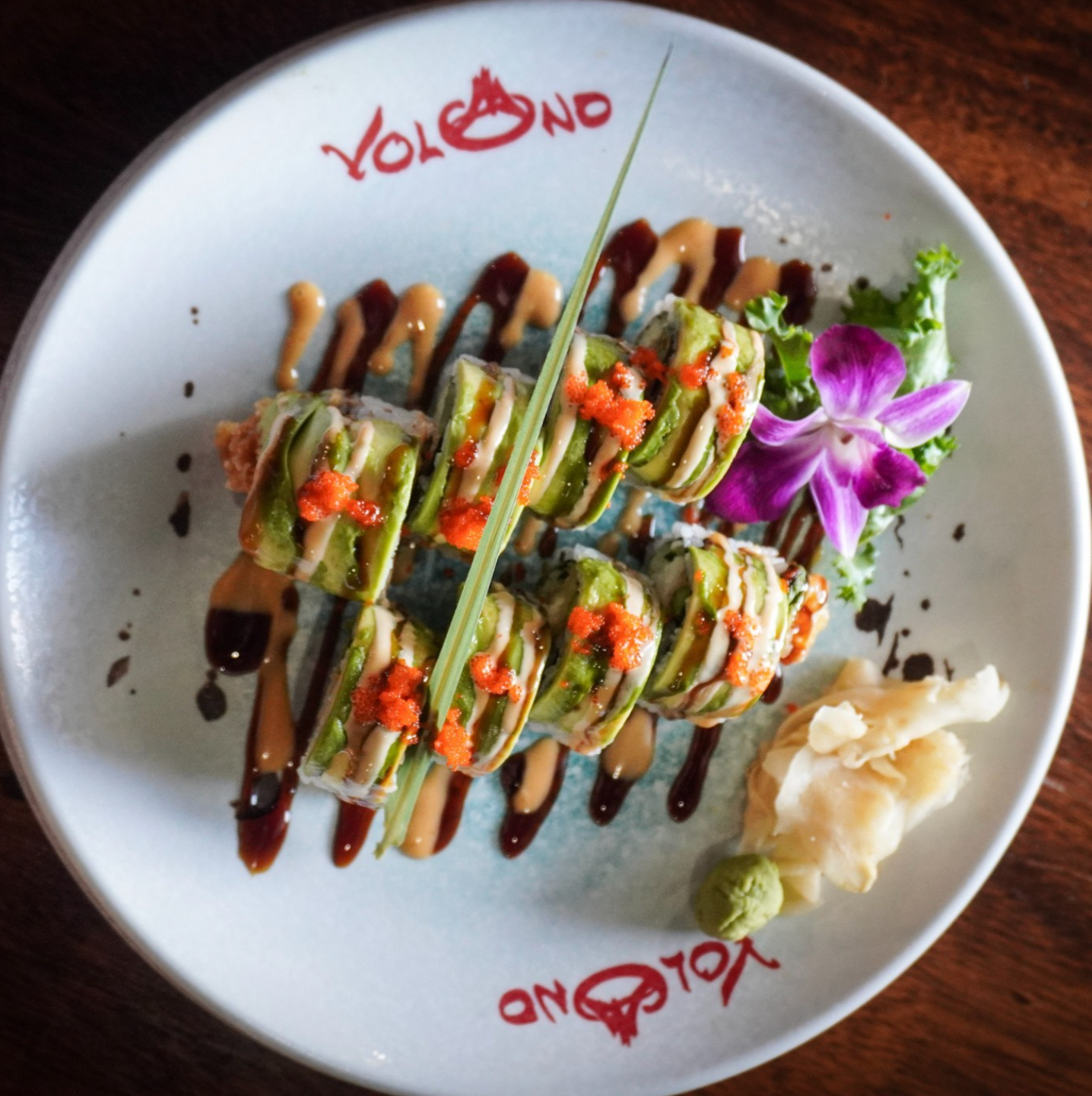 Volcano signature sushi on a branded white plate
